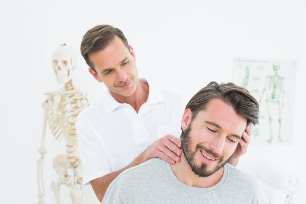 Chiropractor evaluating a patient's neck