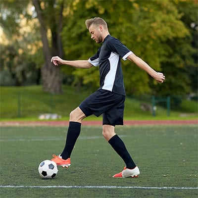Soccer player dribbling ball.