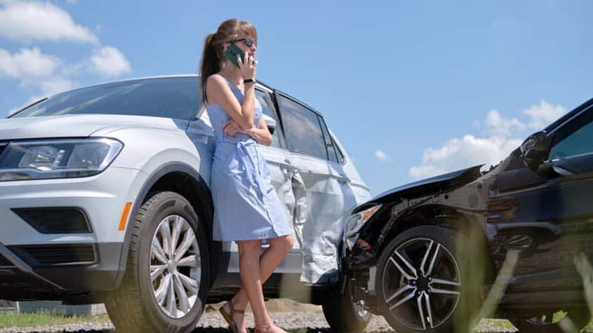 Crashed vehicles and woman contacting