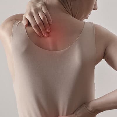 Lady with back pains highlights in red heat spots, along spine.