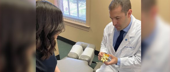 Doctor holding bone to show to patient