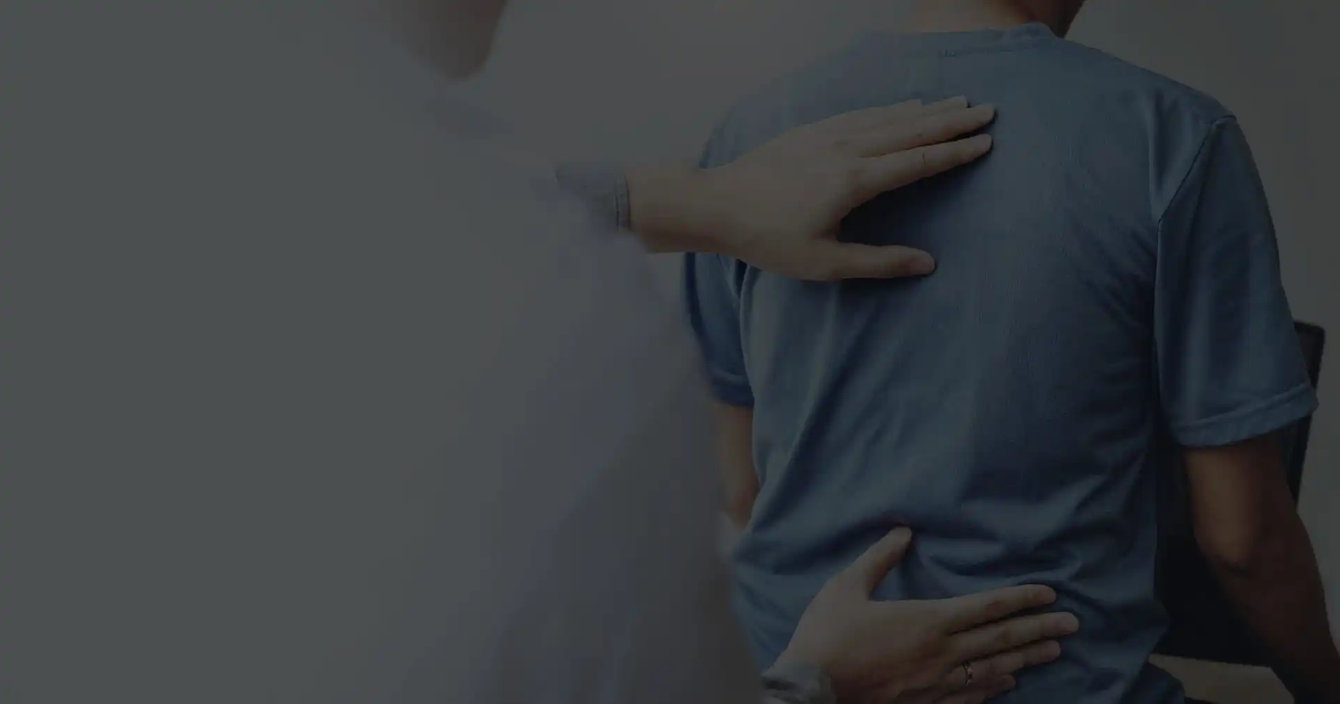 A patient with back pain, chiropractor examining the backbone