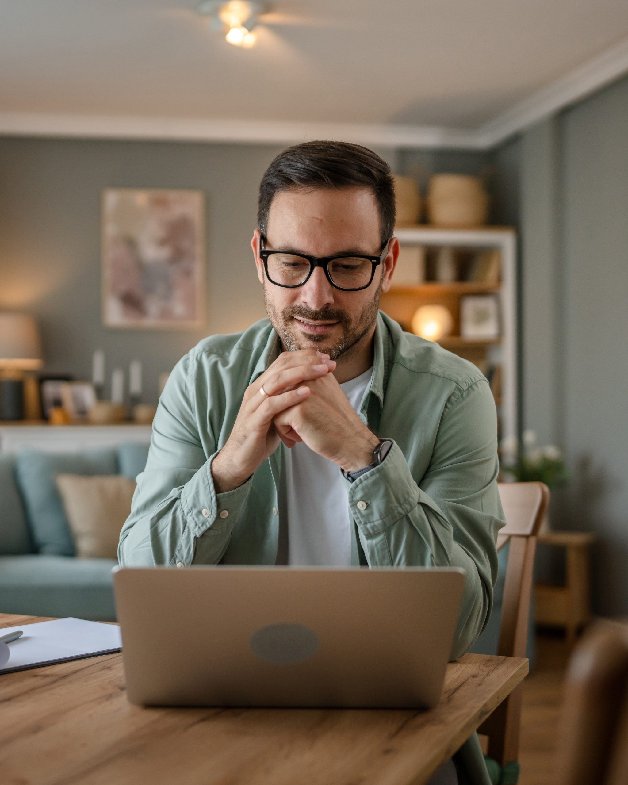 Man smiling while working at home.